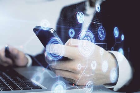 Multi exposure of mans hand holding and using a digital device and data theme drawing. Innovation...