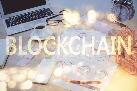 Double exposure of blockchain and crypto economy theme hologram and table with computer background. Concept of bitcoin cryptocurrency.の写真素材