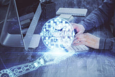 Blockchain theme hud with businessman working on computer on background. Concept of crypto chain. Multi exposure.の写真素材