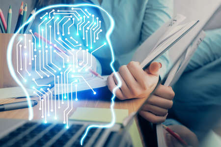 Double exposure of womans writing hand on background with brain hud. Concept of learning.