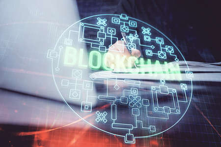 Mans hands working with notes background. Cryptocurrency and finance concept. Double exposure.