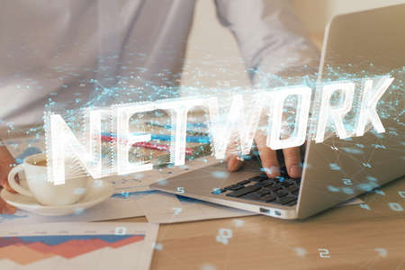 Double exposure of data internet theme hologram with man working on computer on background. Concept...