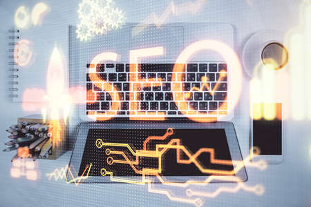 Double exposure of SEO drawing over study table background with computer. Concept of search. Top view.の写真素材