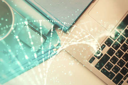 DNA hologram drawings over computer on the desktop background. Top view. Multi exposure. Concept medical education.の写真素材