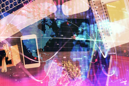 Double exposure of business theme hologram over desktop with phone. Top view. Mobile international trade connection concept.の写真素材