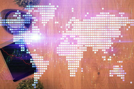 Double exposure of business theme hologram over desktop with phone. Top view. Mobile international...