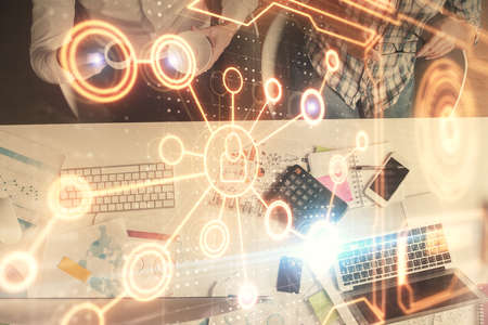 Double exposure of man and woman working together and social network theme hologram drawing....