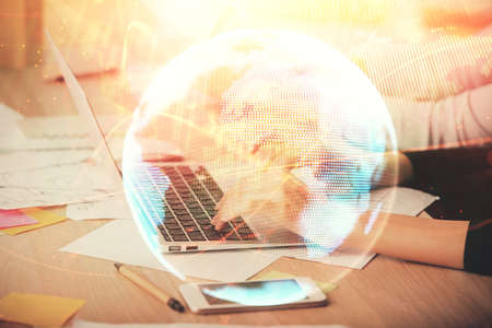 Multi exposure of woman hands typing on computer and business theme hologram drawing. Success...
