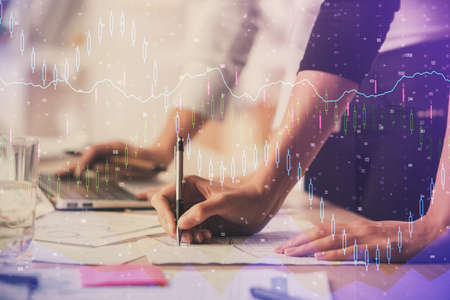 Multi exposure of woman hands typing on computer and financial chart hologram drawing. Stock market...