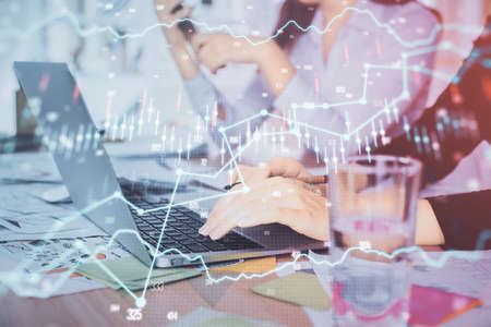 Multi exposure of woman hands typing on computer and forex chart hologram drawing. Stock market...