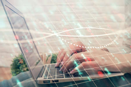 Double exposure of woman hands typing on computer and forex chart hologram drawing. Stock market...