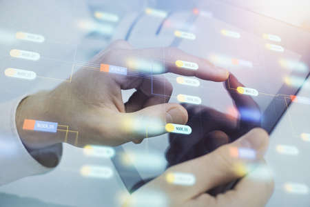 Multi exposure of mans hand holding and using a digital device and data theme drawing. Innovation concept.の写真素材