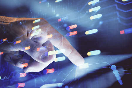 Multi exposure of mans hand holding and using a digital device and data theme drawing. Innovation...