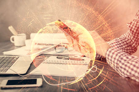 Double exposure of mans hands holding and using a phone and social network theme drawing.