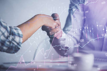 Double exposure of forex graph hologram and handshake of two men. Stock market concept.