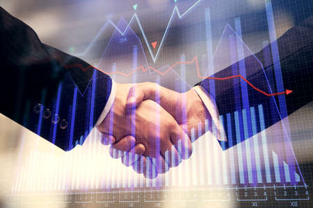 Double exposure of forex graph hologram and handshake of two men. Stock market concept.
