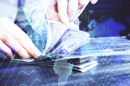 Multi exposure of forex graph drawing hologram and USA dollars bills and man hands. Technical...
