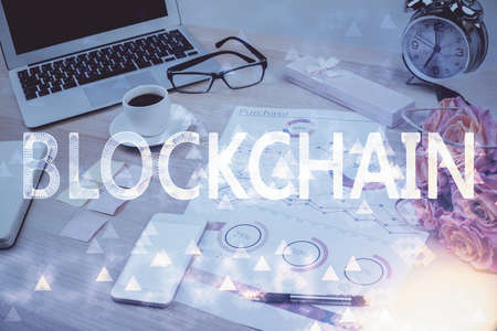 Double exposure of blockchain and crypto economy theme hologram and table with computer background....