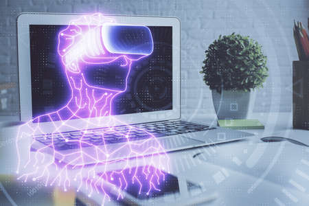 Computer on desktop with AR theme icon. Multi exposure. Concept of augmented reality.の写真素材