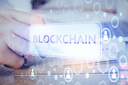 Man's hands working with notes background. Cryptocurrency and finance concept. Double exposure.