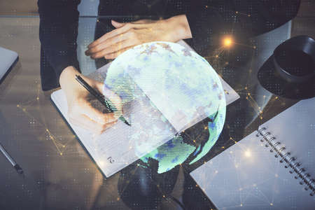 Social network theme hologram over hands taking notes background. Concept of global international...