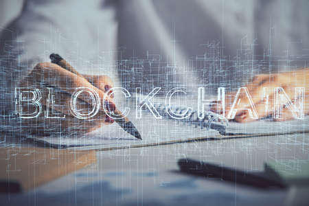Cryptocurrency hologram over womans hands writing background. Concept of blockchain. Double exposureの写真素材