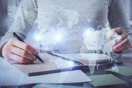 Social network theme hologram over hands taking notes background. Concept of global international...