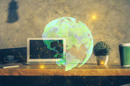 Computer on desktop with social network theme icon. Multi exposure. Concept of international connections.の写真素材