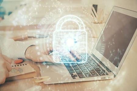 Double exposure of lock icon with man working on computer on background. Concept of network...
