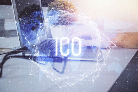 Crypto currency theme hologram with businessman working on computer on background. Concept of...