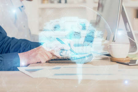 Businessman with computer background with brain theme hologram. Concept of brainstorm. Multi exposure.の写真素材