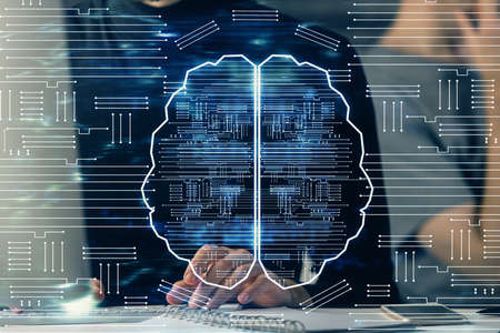 Businessman with computer background with brain theme hologram. Concept of brainstorm. Multi...