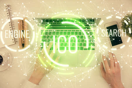 Double exposure of woman hands working on computer and blockchain theme hologram drawing. Top View....