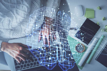 Double exposure of woman working on computer andhuman brain hologram drawing. Top View. Ai concept.の写真素材