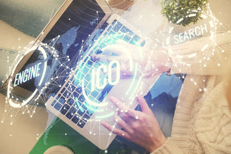 Double exposure of woman hands working on computer and blockchain theme hologram drawing. Top View. bitcoin cryptocurrency concept.の写真素材