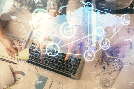 Double exposure of man and woman working together and social network theme hologram drawing....