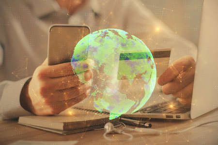 Double exposure of man hands holding a credit card and social network theme drawing. Digital finance...
