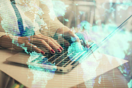 Multi exposure of woman hands typing on computer and business theme hologram drawing. Success...