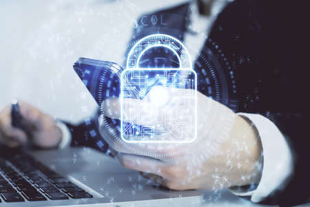 Multi exposure of mans hands holding and using a digital device and lock drawing. Security concept.の写真素材