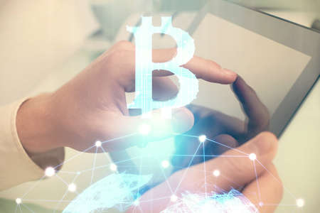 Double exposure of mans hands holding and using a phone and crypto currency blockchain theme drawing.の写真素材