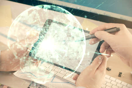 Double exposure of mans hands holding and using a phone and international business theme drawing.