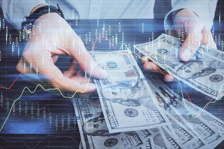 Multi exposure of financial graph drawing hologram and USA dollars bills and man hands. Analysis...
