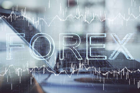 Forex graph hologram on table with computer background. Double exposure. Concept of financial...