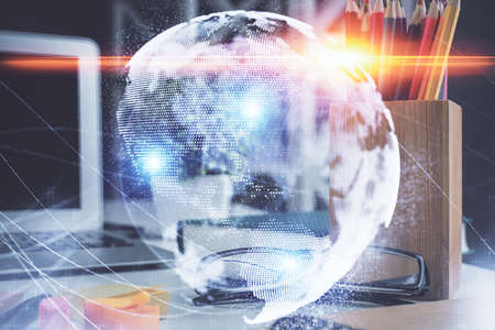 Business theme hologram with glasses on the table background. Concept of search. Double exposure.の写真素材