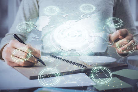 Social network theme hologram over hands taking notes background. Concept of global international...