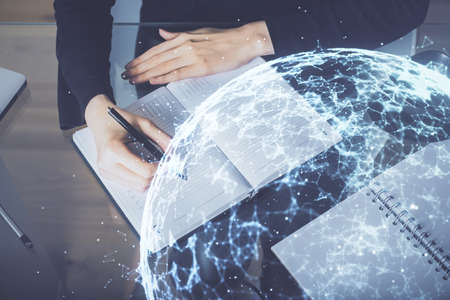 Social network theme hologram over hands taking notes background. Concept of global international people connect. Double exposureの写真素材