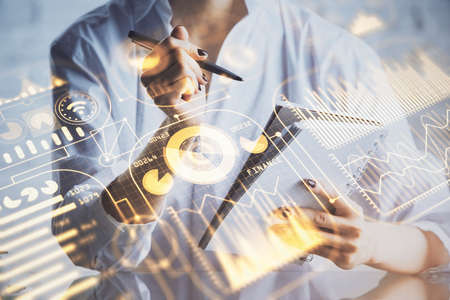 Tech theme hologram over woman's hands taking notes background. Concept of hightech. Double exposure
