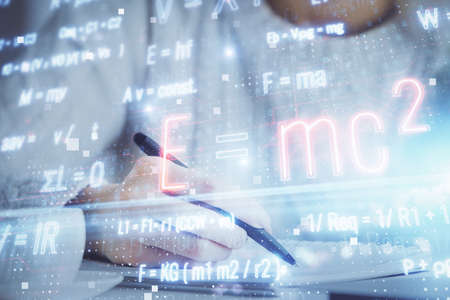 Science formula hologram over womans hands taking notes background. Concept of study. Double...