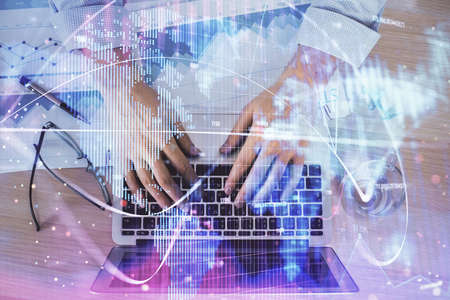 Multi exposure of businessman working on laptop on background. International business hologram in...