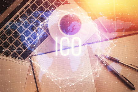 Blockchain theme hologram drawings over computer on the desktop background. Top view. Double...
